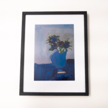 Artwork of a blue vase with blue and flowers, it has who tones of different blues in the background. It is in a black frame.